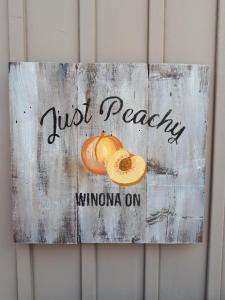 Just Peachy Winnona sign on barnboard