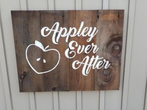 Appley Ever After wedding sign on barnboard